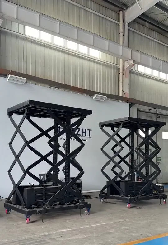 Two rigid chain lift tables raised together during a factory group run test